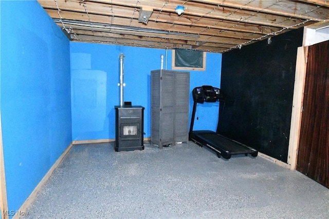 5041 W S Range Rd, Salem, OH 44460 - exercise area featuring a wood stove and baseboards