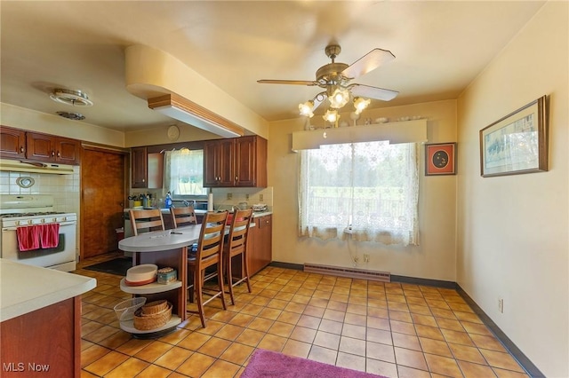 6567 Mount Everett Rd, Hubbard, OH 44425 - kitchen featuring white gas stove, under cabinet range hood, a ceiling fan, and light countertops