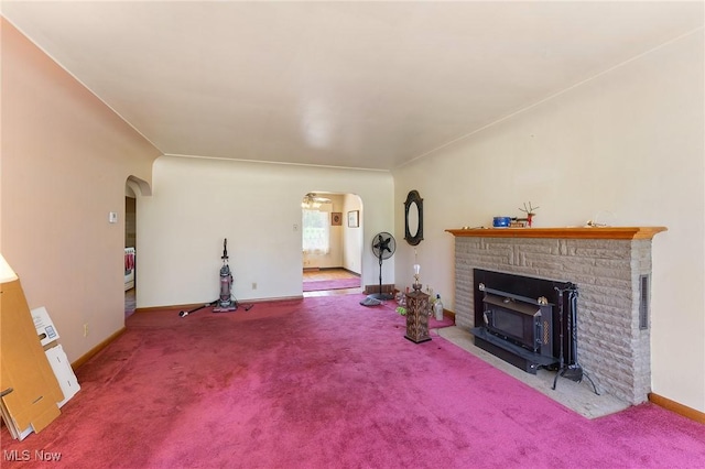 6567 Mount Everett Rd, Hubbard, OH 44425 - unfurnished living room featuring arched walkways, a fireplace, and carpet flooring