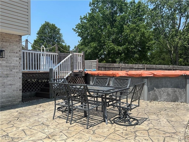 3005 Chaucer Dr NE, Canton, OH 44721 - view of patio featuring stairs, outdoor dining area, and a wooden deck