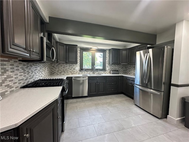 3005 Chaucer Dr NE, Canton, OH 44721 - kitchen featuring stainless steel appliances, tasteful backsplash, and light countertops