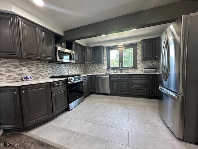 3005 Chaucer Dr NE, Canton, OH 44721 - kitchen featuring stainless steel appliances, backsplash, and light countertops