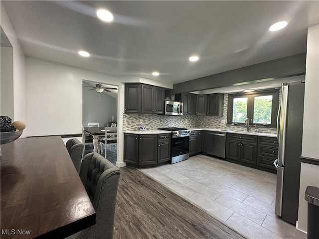 3005 Chaucer Dr NE, Canton, OH 44721 - kitchen featuring stainless steel appliances, light countertops, decorative backsplash, ceiling fan, and recessed lighting