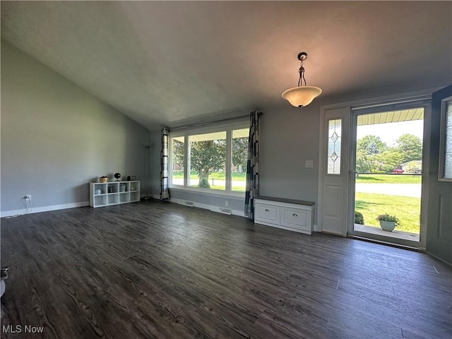 3005 Chaucer Dr NE, Canton, OH 44721 - unfurnished living room featuring dark wood-type flooring and vaulted ceiling