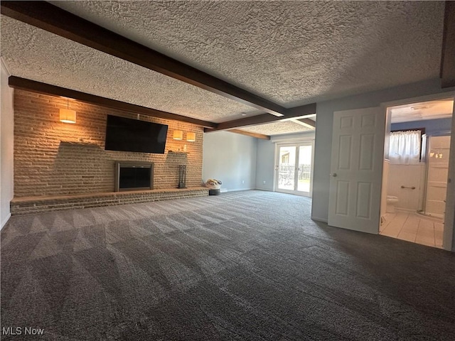 3005 Chaucer Dr NE, Canton, OH 44721 - unfurnished living room featuring carpet floors, a textured ceiling, beamed ceiling, and a brick fireplace