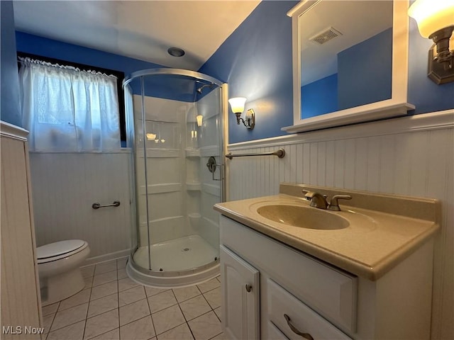 3005 Chaucer Dr NE, Canton, OH 44721 - bathroom featuring tile patterned flooring, a shower stall, vanity, and wainscoting