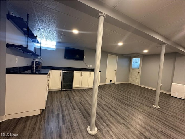 3005 Chaucer Dr NE, Canton, OH 44721 - below grade area with wine cooler, wet bar, dark wood finished floors, healthy amount of natural light, and recessed lighting