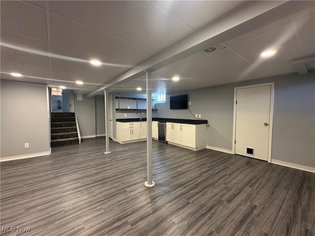 3005 Chaucer Dr NE, Canton, OH 44721 - finished basement featuring dark wood-type flooring, stairway, and bar