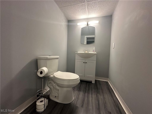 3005 Chaucer Dr NE, Canton, OH 44721 - half bathroom with a paneled ceiling, vanity, and wood finished floors