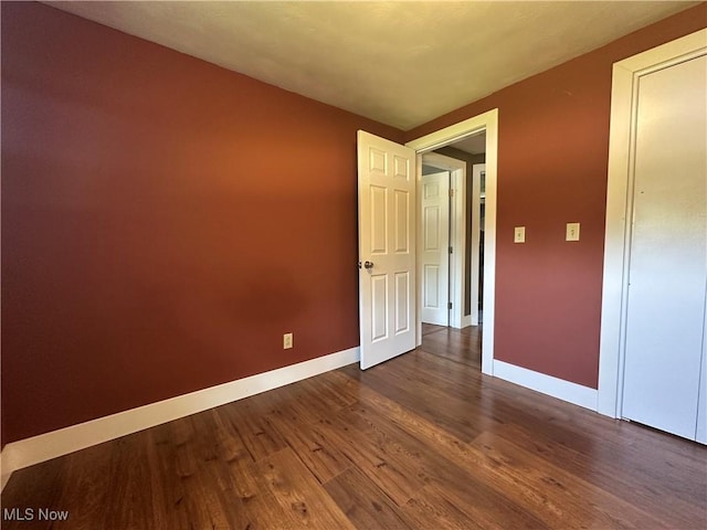 3005 Chaucer Dr NE, Canton, OH 44721 - spare room featuring baseboards and dark wood-style flooring