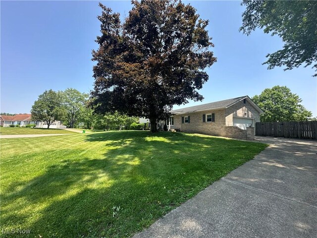 3005 Chaucer Dr NE, Canton, OH 44721 - view of front of home with brick siding, a garage, and concrete driveway