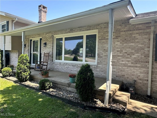 3005 Chaucer Dr NE, Canton, OH 44721 - entrance to property featuring brick siding, covered porch, and a chimney
