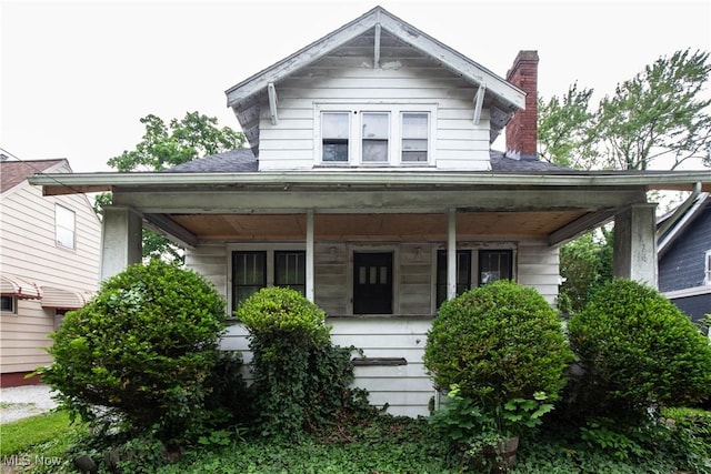 774 Storer Ave, Akron, OH 44320 - view of front facade with a porch and a chimney