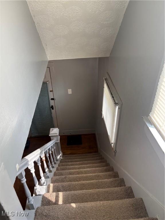 11 Front St, Rittman, OH 44270 - stairs with a textured ceiling