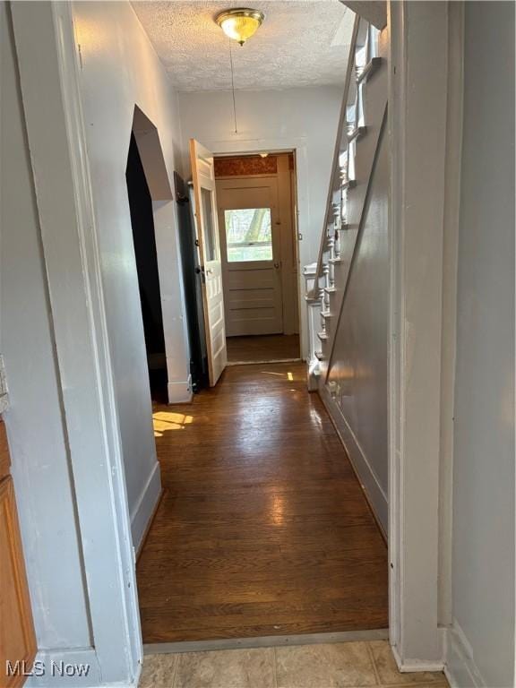 11 Front St, Rittman, OH 44270 - corridor featuring a textured ceiling, stairs, and wood finished floors
