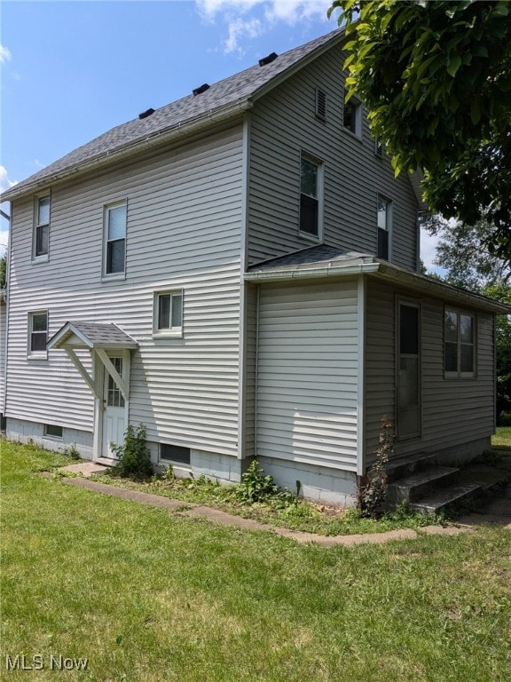 11 Front St, Rittman, OH 44270 - back of house featuring a lawn and entry steps