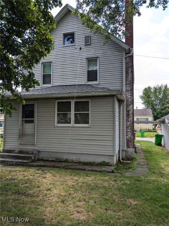 11 Front St, Rittman, OH 44270 - rear view of property with a lawn and a chimney