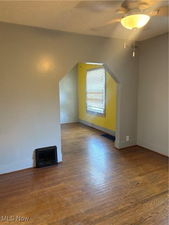 11 Front St, Rittman, OH 44270 - additional living space featuring wood finished floors, a ceiling fan, and a textured ceiling
