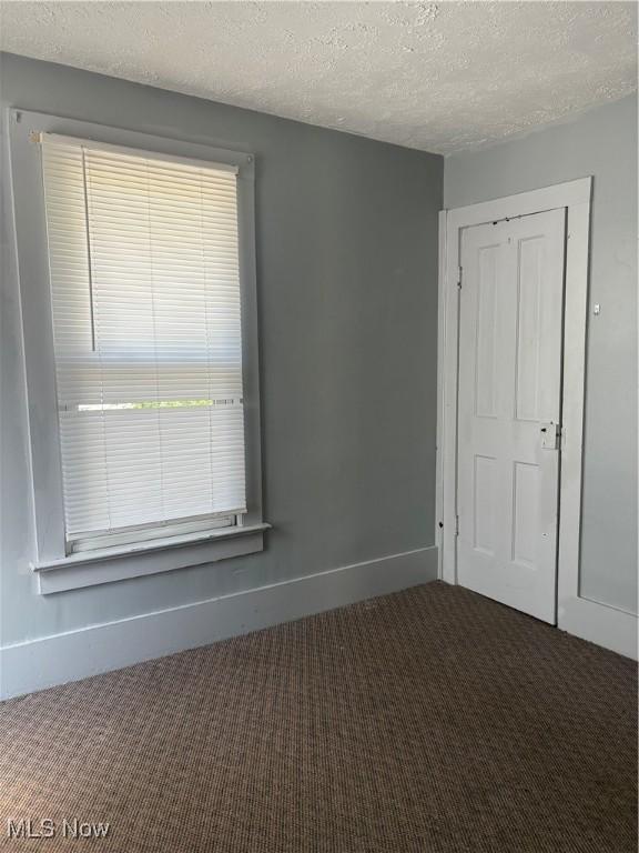 11 Front St, Rittman, OH 44270 - unfurnished bedroom with carpet flooring and a textured ceiling