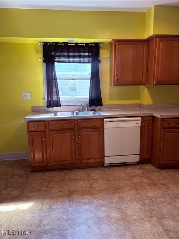 11 Front St, Rittman, OH 44270 - kitchen with dishwasher, brown cabinets, and light countertops