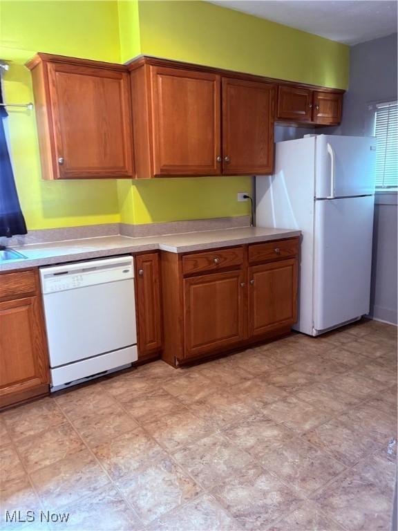 11 Front St, Rittman, OH 44270 - kitchen with white appliances, light countertops, and brown cabinets