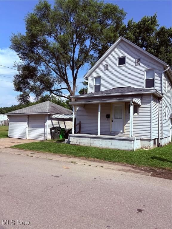 11 Front St, Rittman, OH 44270 - view of front of property with a porch, a garage, and an outdoor structure