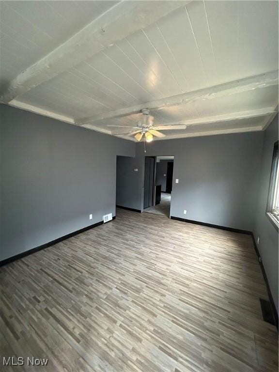 3351 E 65th St, Cleveland, OH 44127 - unfurnished room featuring wood finished floors, a ceiling fan, and beam ceiling