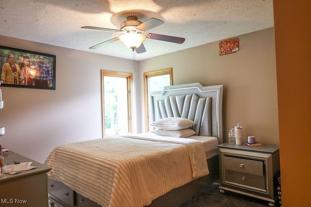 620 Ridgeline Dr, Cuyahoga Falls, OH 44223 - bedroom with a textured ceiling, a ceiling fan, and dark colored carpet