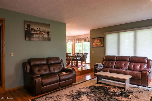 620 Ridgeline Dr, Cuyahoga Falls, OH 44223 - living area featuring wood finished floors, a chandelier, and a textured ceiling
