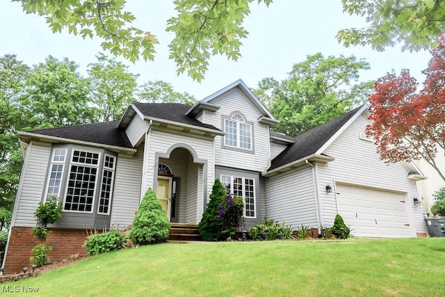 620 Ridgeline Dr, Cuyahoga Falls, OH 44223 - traditional-style house featuring a front lawn, an attached garage, and a shingled roof