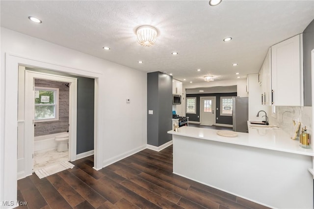10310 Thrush Ave, Cleveland, OH 44111 - kitchen featuring appliances with stainless steel finishes, white cabinetry, light countertops, healthy amount of natural light, and recessed lighting