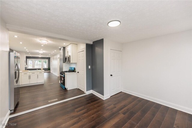 10310 Thrush Ave, Cleveland, OH 44111 - kitchen with appliances with stainless steel finishes, dark wood-style floors, white cabinets, a textured ceiling, and recessed lighting
