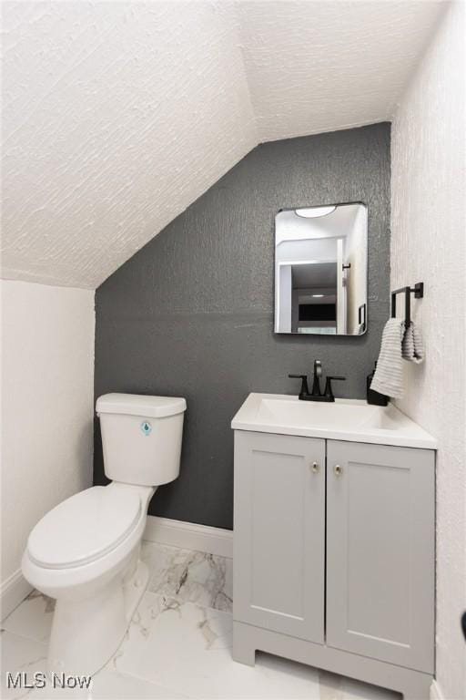10310 Thrush Ave, Cleveland, OH 44111 - half bath featuring vaulted ceiling, vanity, a textured ceiling, and marble look tile flooring
