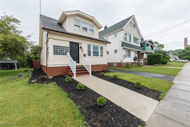10310 Thrush Ave, Cleveland, OH 44111 - view of front of house with entry steps, a front yard, and crawl space