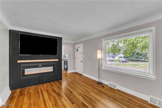 6207 Dartworth Dr, Parma, OH 44129 - unfurnished living room featuring a glass covered fireplace and wood finished floors