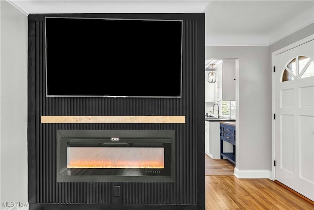 6207 Dartworth Dr, Parma, OH 44129 - detailed view of a fireplace, wood finished floors, and crown molding