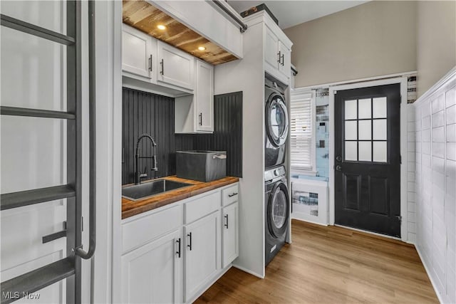 6207 Dartworth Dr, Parma, OH 44129 - laundry room with stacked washer / dryer and light wood-style flooring