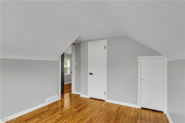 6207 Dartworth Dr, Parma, OH 44129 - additional living space featuring wood-type flooring and vaulted ceiling