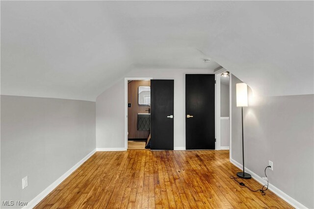 6207 Dartworth Dr, Parma, OH 44129 - additional living space featuring hardwood / wood-style flooring and vaulted ceiling