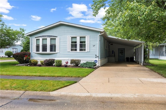 8 Symphony St, Olmsted Twp, OH 44138 - manufactured / mobile home with an attached carport, driveway, and a front yard