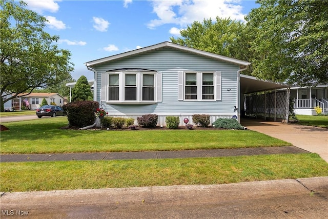 8 Symphony St, Olmsted Twp, OH 44138 - manufactured / mobile home featuring driveway, a front yard, and an attached carport