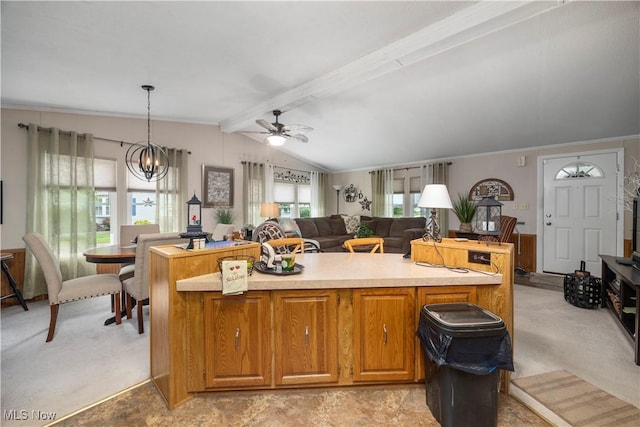 8 Symphony St, Olmsted Twp, OH 44138 - kitchen with a ceiling fan, a kitchen island, light countertops, a chandelier, and ornamental molding