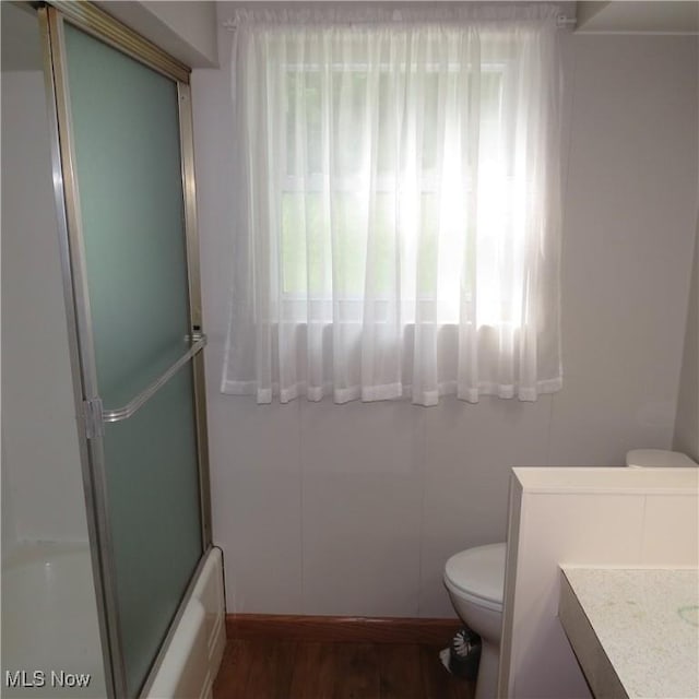 399 N Main St, Amsterdam, OH 43903 - full bath with vanity, wood finished floors, and enclosed tub / shower combo