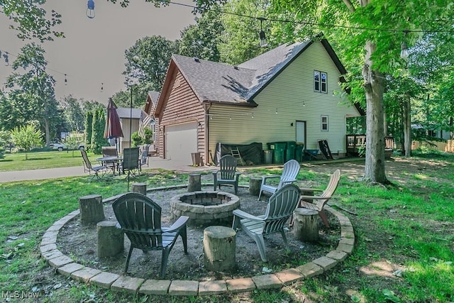 5710 Cardinal Dr, Mentor, OH 44060 - rear view of property featuring an outdoor fire pit, a lawn, and a shingled roof