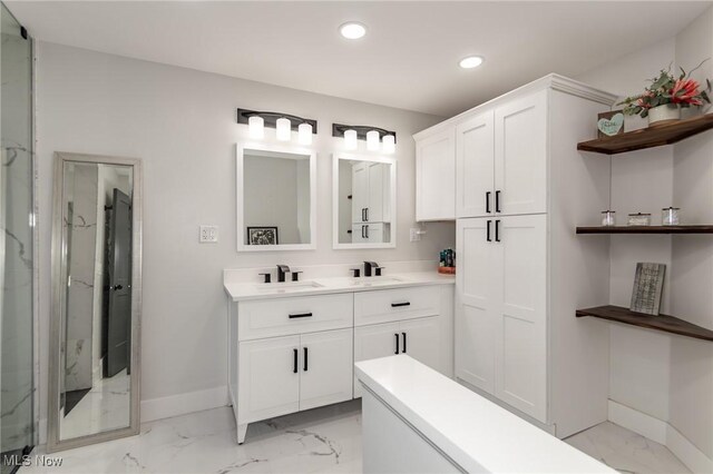 5710 Cardinal Dr, Mentor, OH 44060 - full bath featuring marble look tile flooring, recessed lighting, double vanity, and a marble finish shower