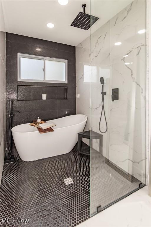 5710 Cardinal Dr, Mentor, OH 44060 - full bathroom featuring a marble finish shower, tile walls, and a freestanding bath