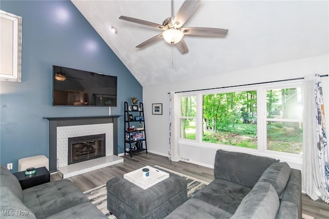 5710 Cardinal Dr, Mentor, OH 44060 - living area featuring ceiling fan, wood finished floors, vaulted ceiling, and a tile fireplace