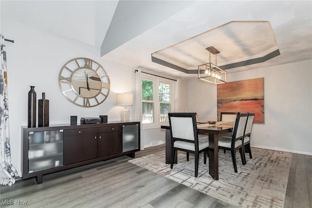 5710 Cardinal Dr, Mentor, OH 44060 - dining area featuring a tray ceiling, light wood-type flooring, and a chandelier