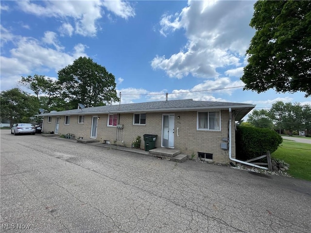 233 Kennedy St, Louisville, OH 44641 - view of front of property featuring brick siding and roof with shingles