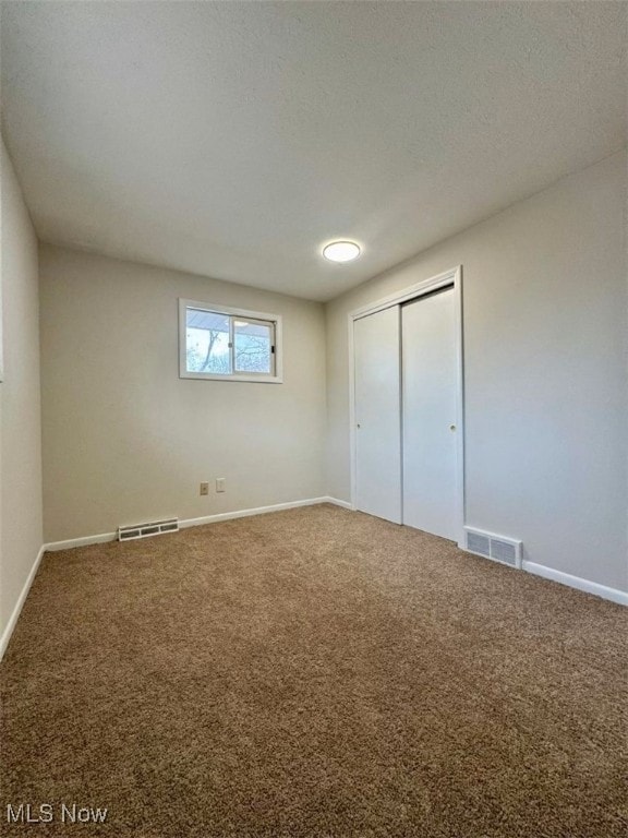 233 Kennedy St, Louisville, OH 44641 - unfurnished bedroom with carpet floors and a closet